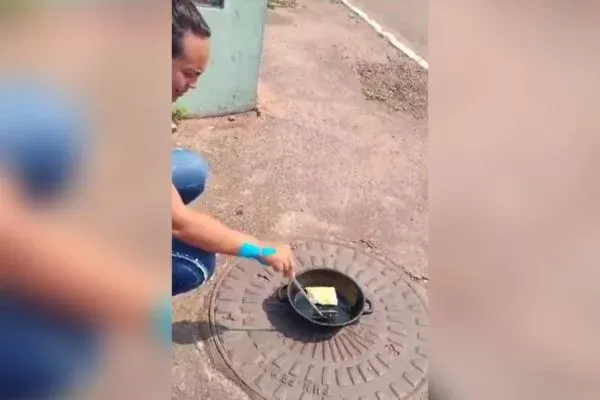 Calorão! Com 44ºC, moradora frita pastel em calçada de Cuiabá